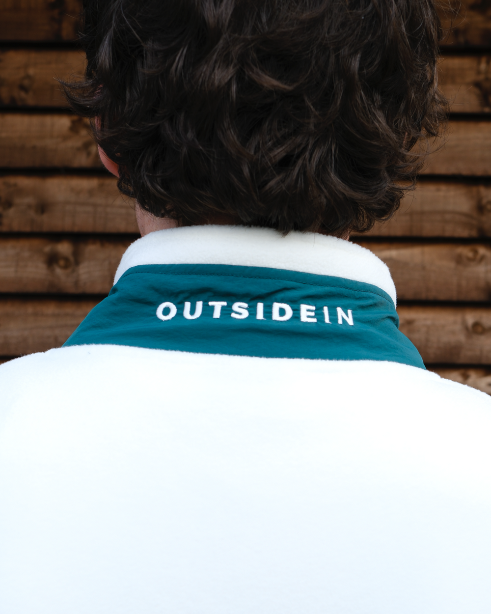 OutsideIn cream and pine green unisex fleece close up