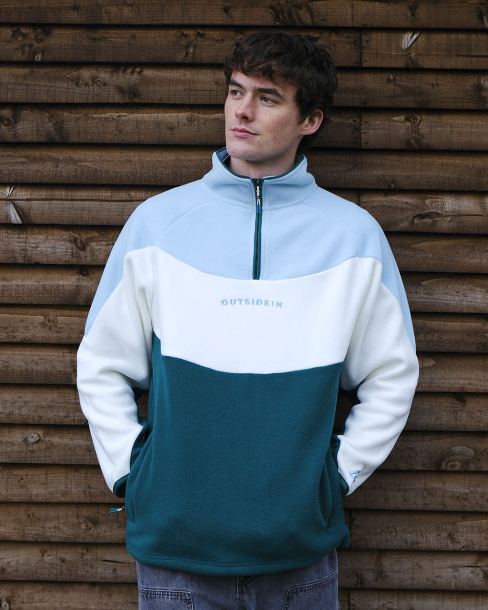 Model wearing OutsideIn Coastal Wave Unisex Fleece