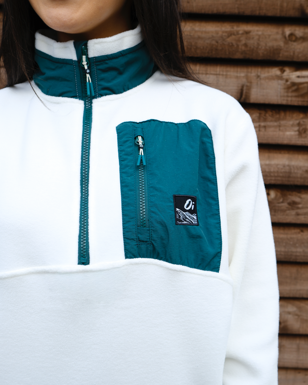 OutsideIn cream and pine green unisex fleece pocket close-up