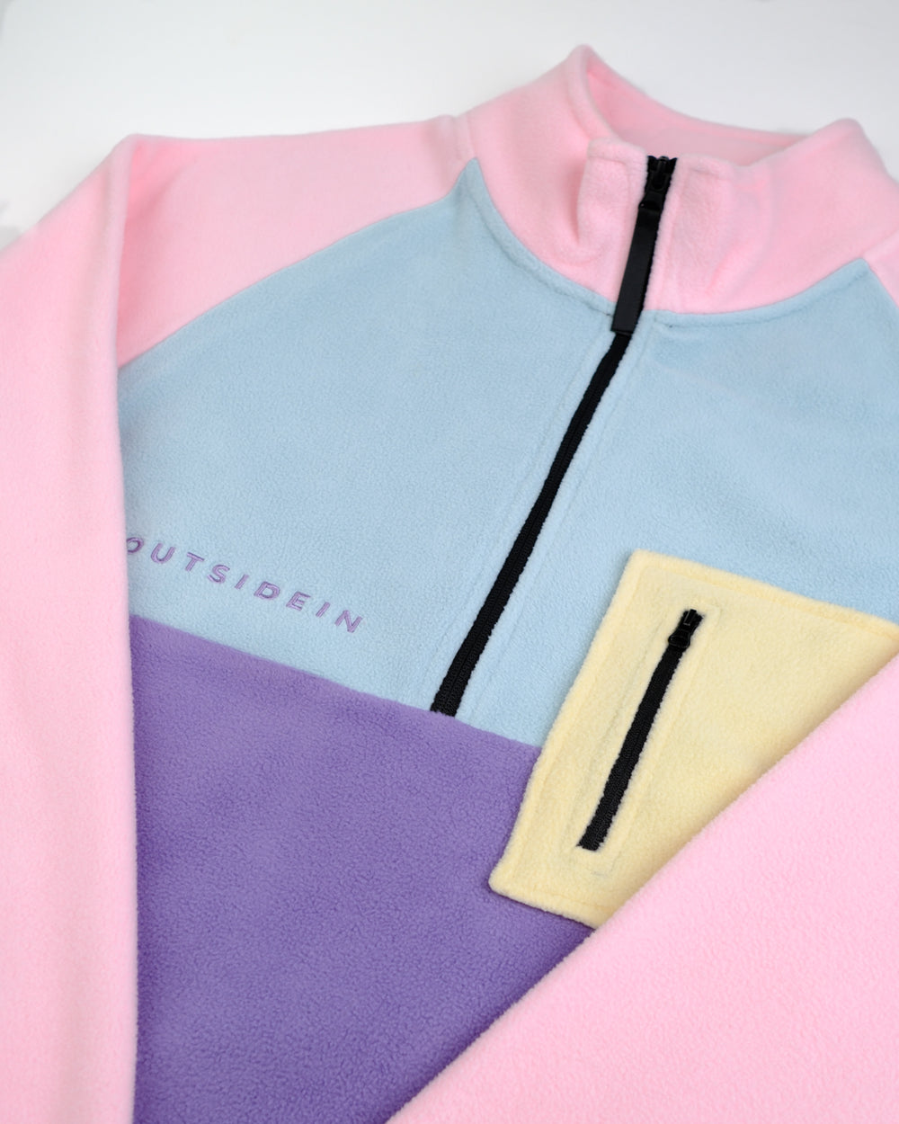 Petal Bloom Outside In fleece with a zipper and 'OUTSIDEIN' branding on a white background