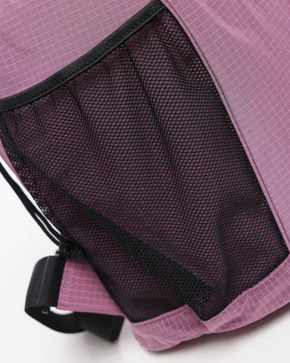 Close up of side netting on OutsideIn Pink Black Drawstring Daypack