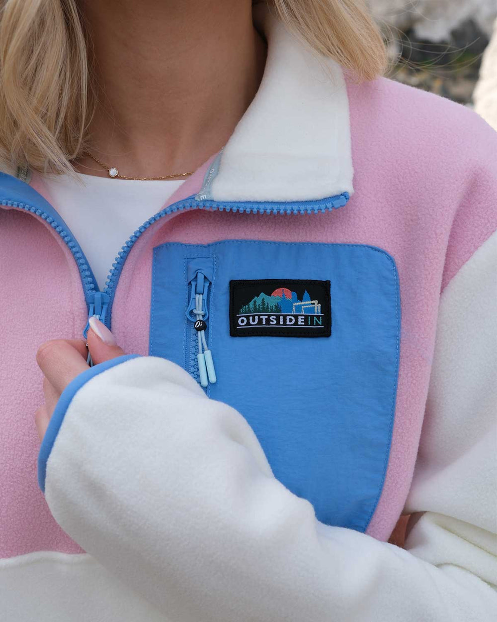 Close up of Pink and Blue Signature Pocket Fleece logo