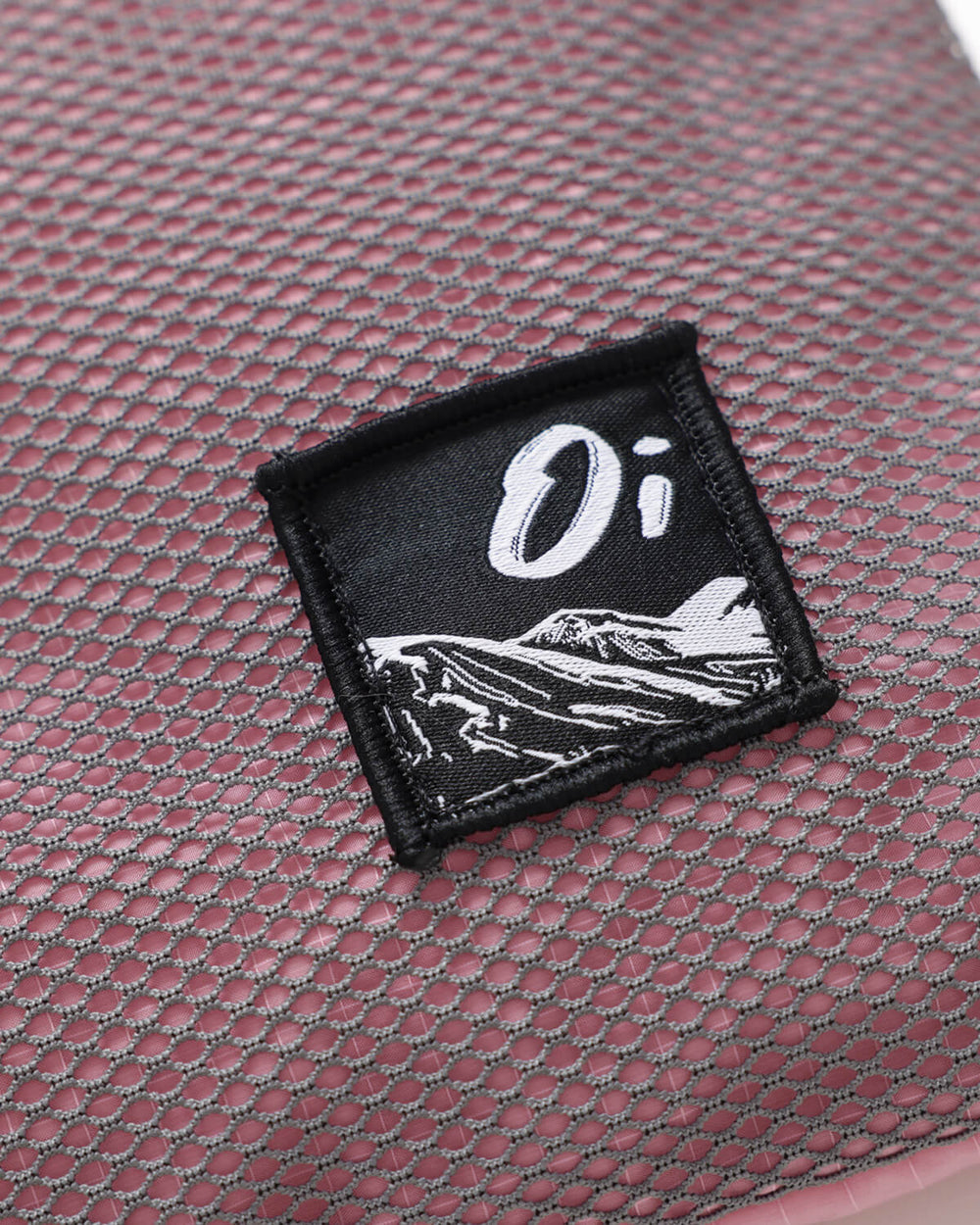 Close up of OutsideIn Pink Grey Lightweight Sling Bag Label