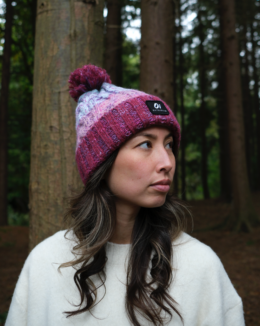 Maroon and pastel knit beanie with pom pom and brand patch