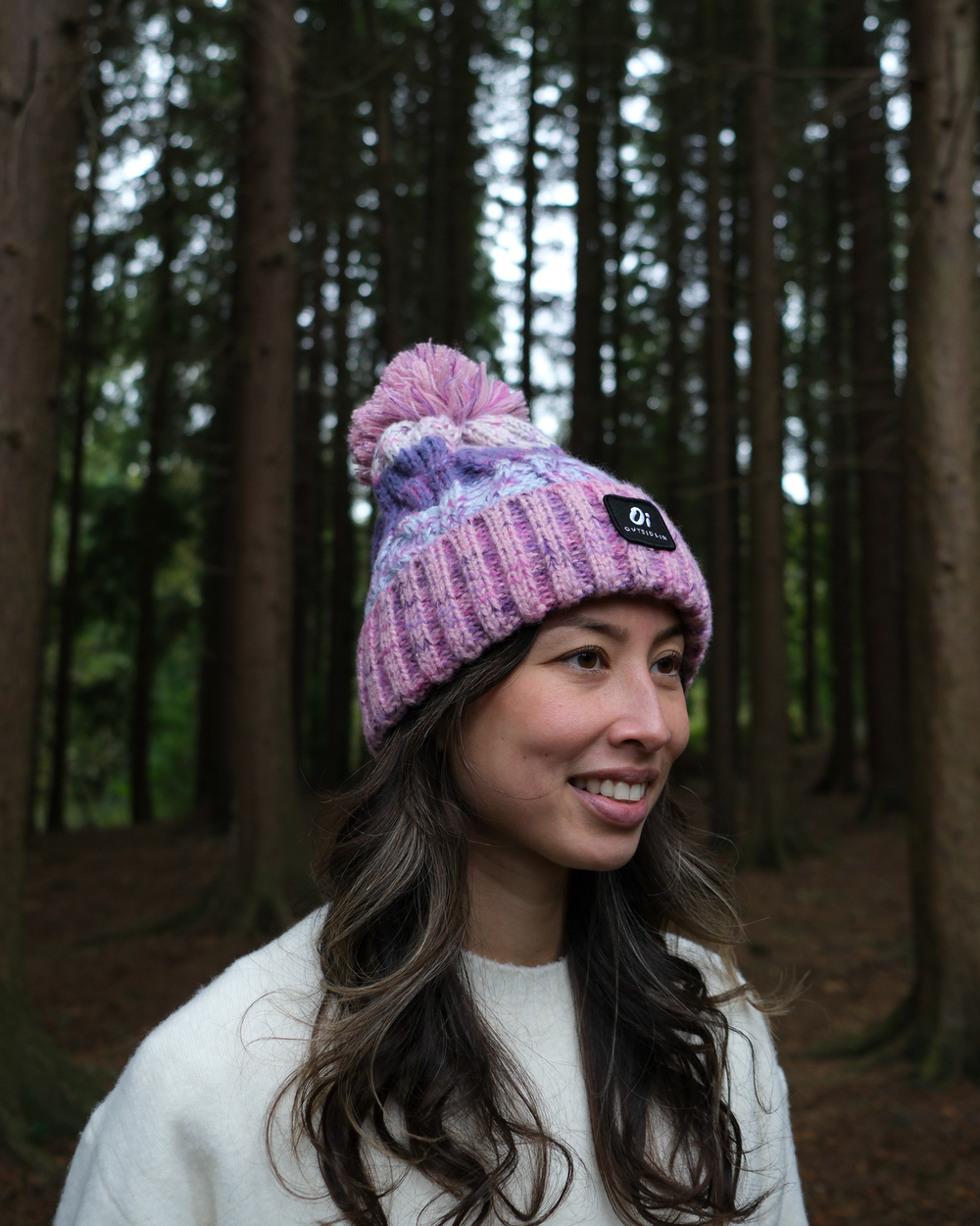 Lavender knit beanie with pom-pom and small logo patch on cuff