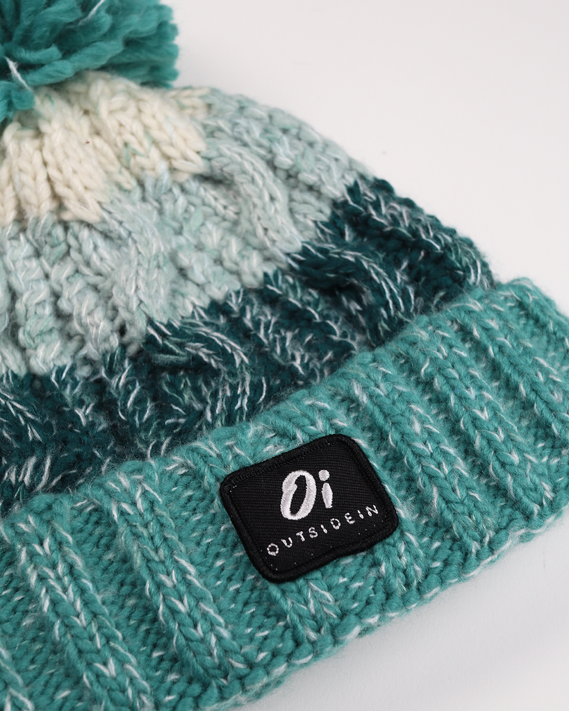 Sea Foam Pom hat with partial faux shearling lining and acrylic knit