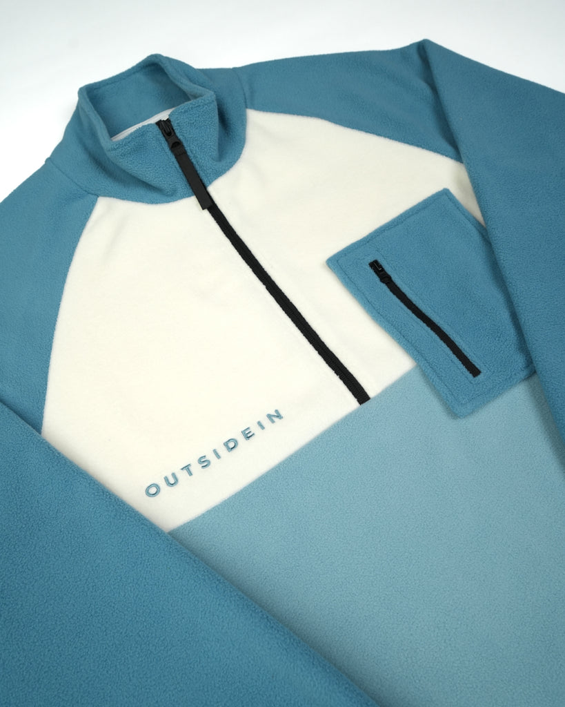 Unisex teal cream fleece with quarter zip, front pocket and toggle detail
