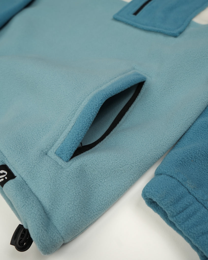 Unisex teal cream fleece with quarter zip, front pocket and toggle detail