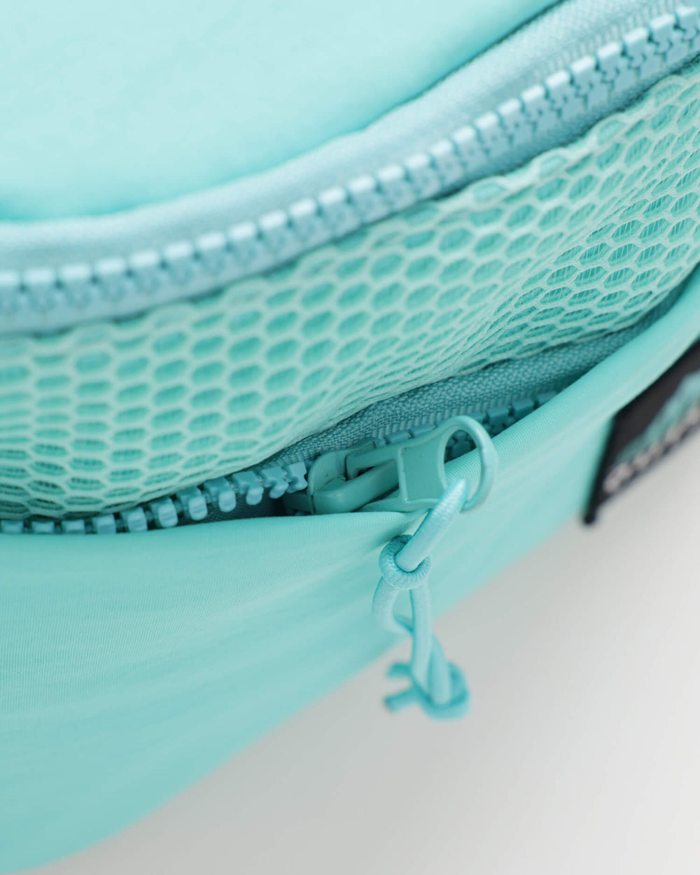 Close up of OutsideIn Turquoise Blue Bum Bag Zip