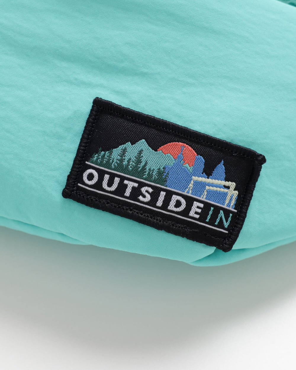 Close up of OutsideIn Turquoise Blue Bum Bag Label
