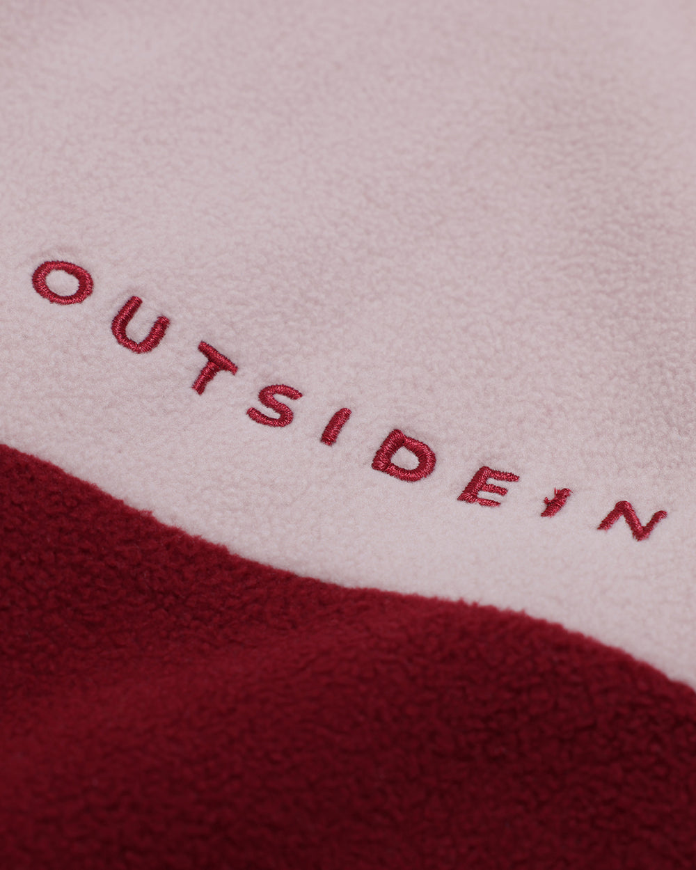 Close-up of 'OUTSIDEIN' embroidered on Wild Mulberry Pocket Fleece 1/2 zip