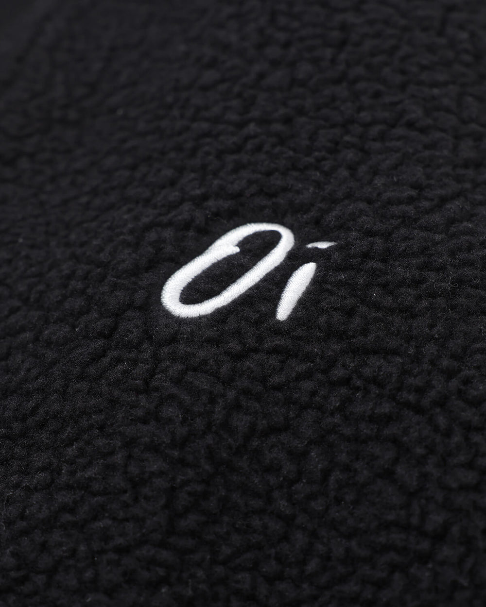 Close-up of OutsideIn Black Zip Essential Fleece.