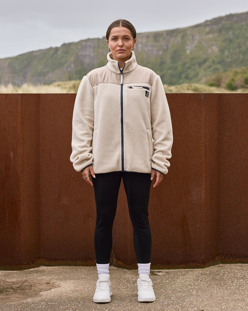 Oatmilk borg fleece with full zip, nylon contrast panels, and zip pockets