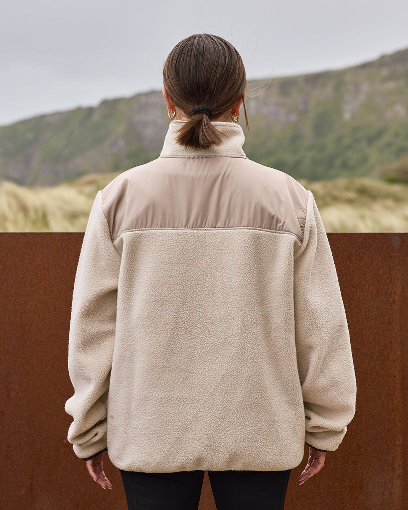 Oatmilk borg fleece with full zip, nylon contrast panels, and zip pockets