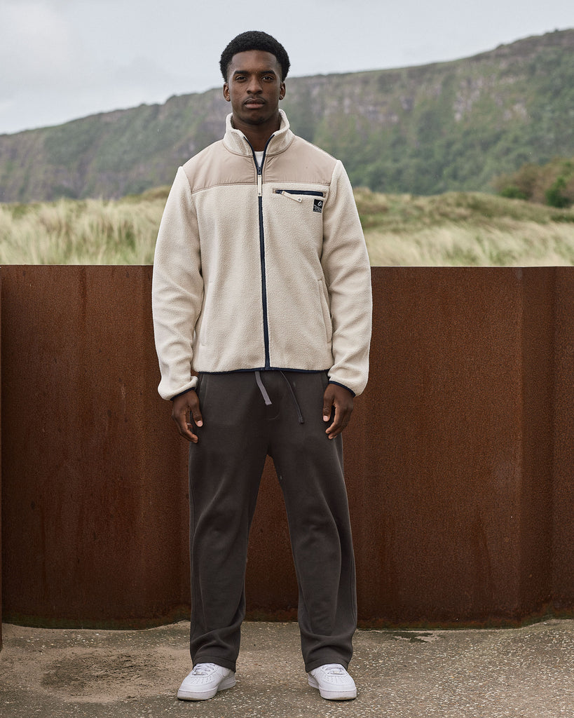 Oatmilk borg fleece with full zip, nylon contrast panels, and zip pockets