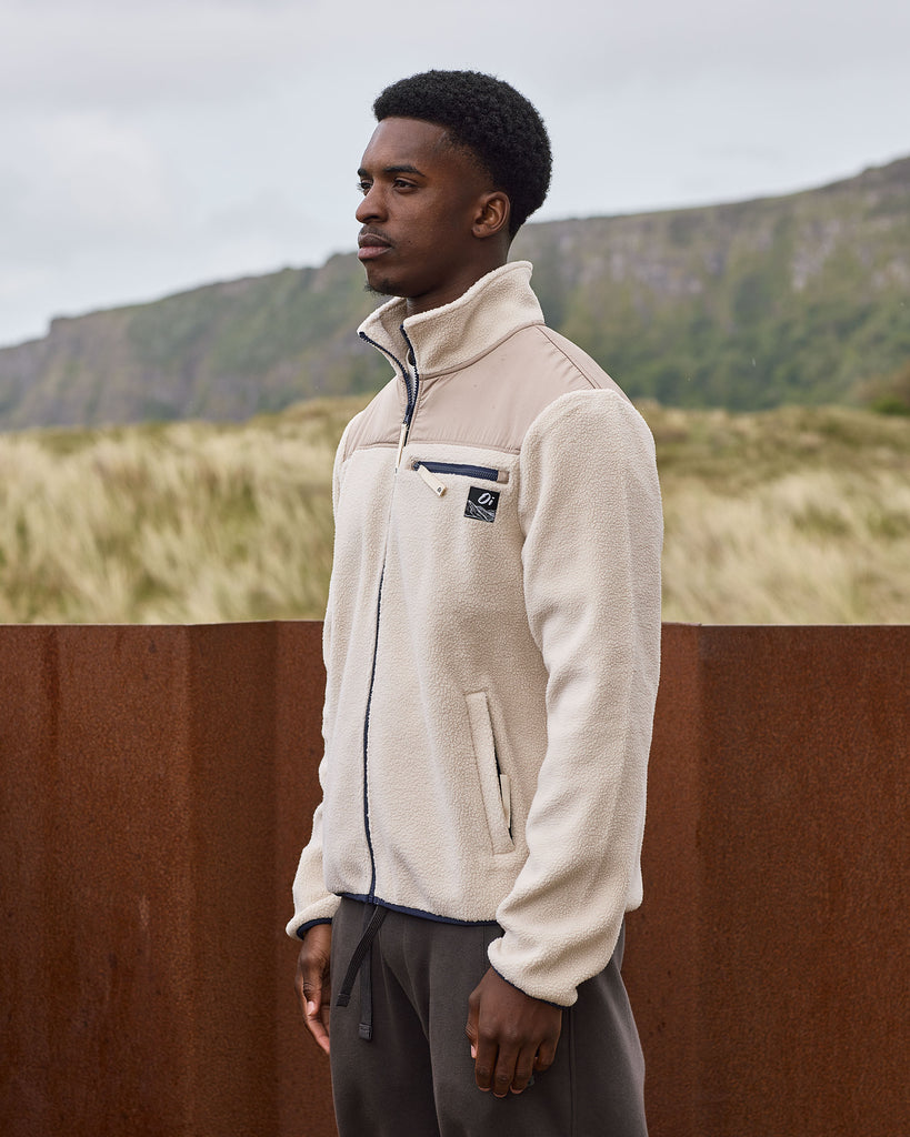 Oatmilk borg fleece with full zip, nylon contrast panels, and zip pockets