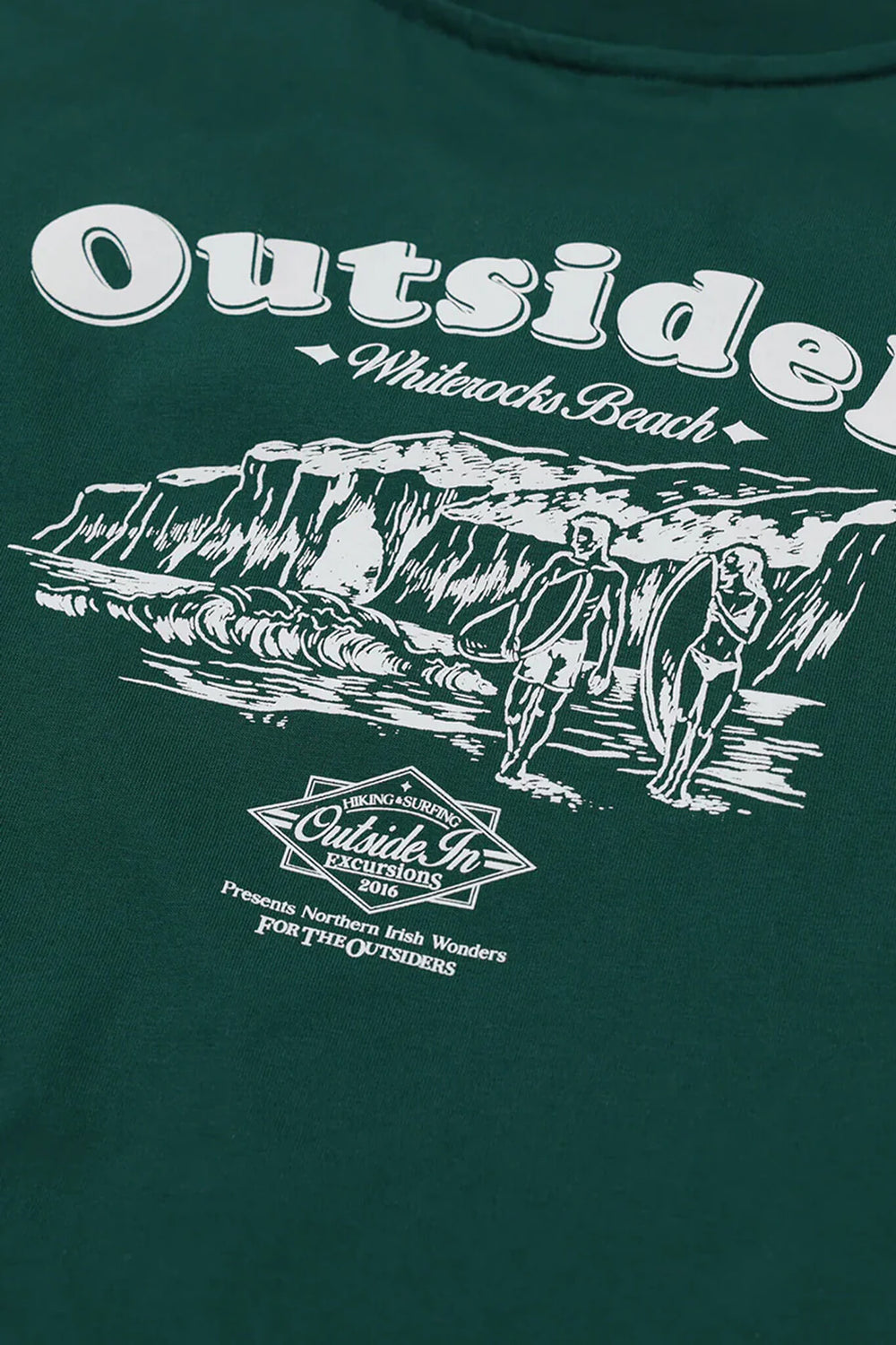 Green t-shirt with white graphic design of people at a beach and 'Outside In' branding.